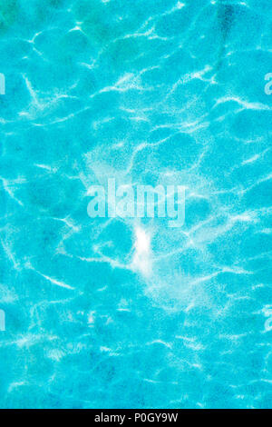 Reflected sunlight creates abstract patterns in outdoor swimming pool Stock Photo