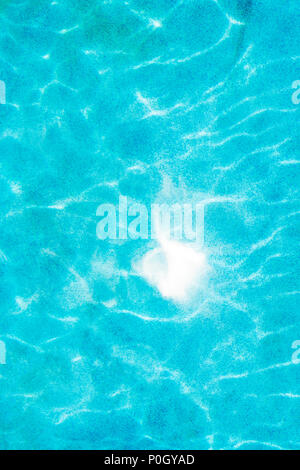 Reflected sunlight creates abstract patterns in outdoor swimming pool Stock Photo