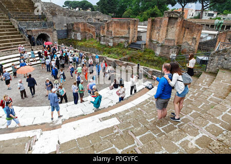 Tourists taking selfies at an ancient roman amphitheatre, Pompeii Archaeological site, Pompeii, Campania, Italy, Stock Photo