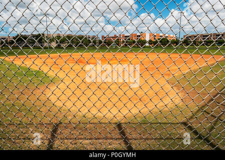 Public park baseball diamond viewed through cyclone fence; south central Florida; USA Stock Photo