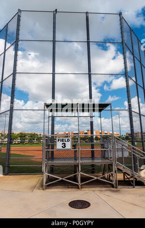 Public park baseball diamond viewed through cyclone fence; south central Florida; USA Stock Photo