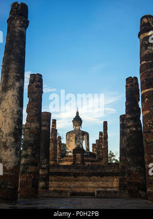 Buddha statue and columns in historical park, Sukhothai Thailand Stock Photo