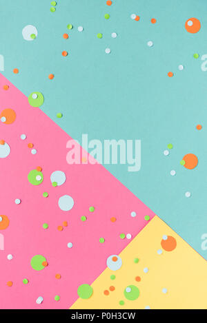 Vibrant confetti on multicolored pink, blue, yellow background with white clean blank for your text. Festive backdrop for your design, copy space. Stock Photo