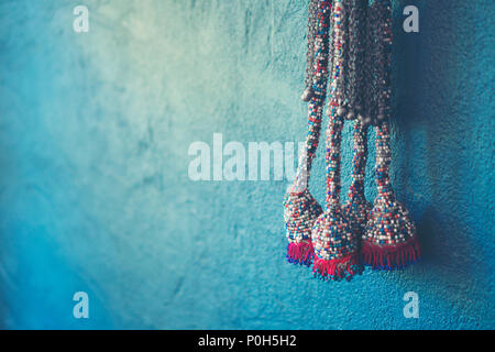 Blue wall background with knitting yarn Stock Photo