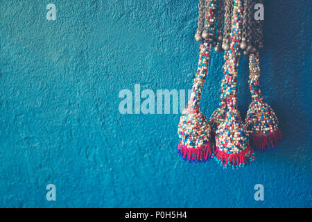 Blue wall background with knitting yarn Stock Photo
