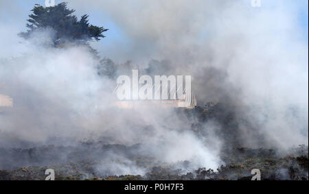 Firefighters battle a gorse fire at Howth Head in Dublin as the hot ...