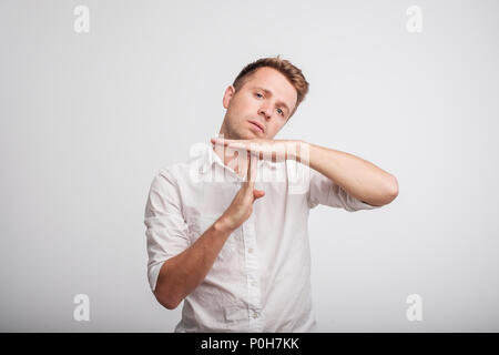 Young caucasian man tired and bored, making a timeout gesture. Stock Photo