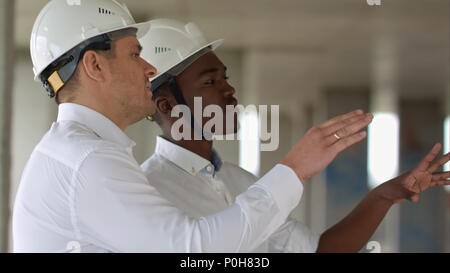 Two businessman discussing project at construction site Stock Photo