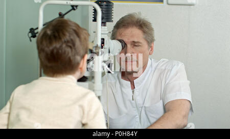 Optometrist doing sight testing for little pateient Stock Photo