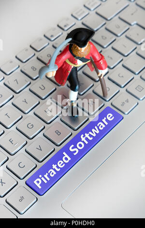 Small Miniature Pirate Standing On A Keyboard (Pirated Software) Stock Photo