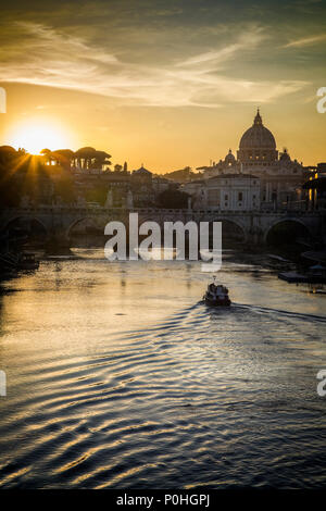 A boat travels the Tiber River in front of St. Peters Basilica in the Vatican in Rome, Italy. Stock Photo