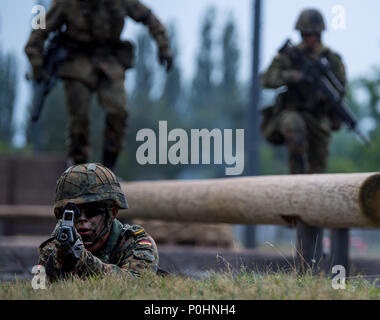 Germany, Dresden, 09 June 2018, A soldier lies on the ground holding a weapon at a public presentation. 'Bundeswehr Day' comprises various events nation-wide to recruit young people for military service. Photo: Monika Skolimowska/dpa-Zentralbild/dpa Stock Photo