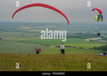 Alciston, Polegate, East Sussex, UK..9 June 2018..Overcast skies with wind from the NE brings paraglider pilots to the South Downs, Bo-Peep hill. Stock Photo