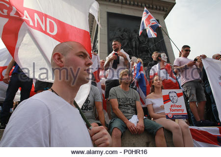 London, UK, 9 June 2018. A demonstration has been held in Central London in support of Tommy Robinson. A large crowd of his supporters marched from Trafalgar Square to Downing Street. A counter demonstration was held some distance away and a large police force was present. In this shot a young man holds an England flag aloft as repeated calls for Robinson's release are shouted out. Credit: Clearpix/Alamy Live News Credit: Clearpix/Alamy Live News Stock Photo