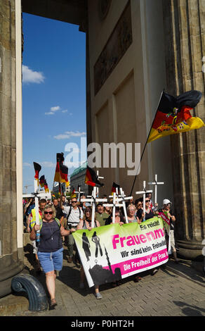 Berlin, Germany. 09th June, 2018. 09 June 2018, Germany, Berlin: The 'Frauenmarsch' (lit. women's march) by right-wing populist groups walks through the Brandenburg Gate. Credit: Jörg Carstensen/dpa/Alamy Live News Stock Photo