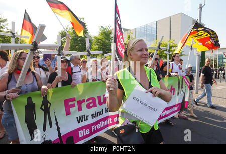 Berlin, Germany. 09th June, 2018. 09 June 2018, Germany, Berlin: The 'Frauenmarsch' (lit. women's march) by right-wing populist groups passes the German chancellery. Credit: Jörg Carstensen/dpa/Alamy Live News Stock Photo