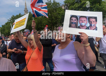 London, UK. June 9th 2018. Women hold posters and a Unifon flag as around a thousand gather in Trafalgar Square on and around the plinth of Nelson's column to march to a rally in Whitehall. They were were chanting and singing for Tommy Robinson, a man who pleaded guilty to contempt of court and whose actions could have led to a trial being stopped, to be freed from jail, claiming his arrest was an attack on free speech. A small counter protest took place a few hundred yards away, with several lines of police keeping the two groups well apart. Peter Marshall/Alamy Live News Credit: Peter Marsha Stock Photo