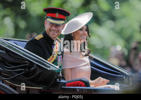 London, UK. 9th June 2018. HRH Prince Harry and his wife, Meghan, now titled the Duke and Duchdess of Sussex, ride in a horse drawn carriage in the procession along The Mall at Trooping the Colour, The Queens Birthday Parade. London.  This is Meghan, Duchess of Sussex first appearance at the procession. Credit: amanda rose/Alamy Live News Stock Photo