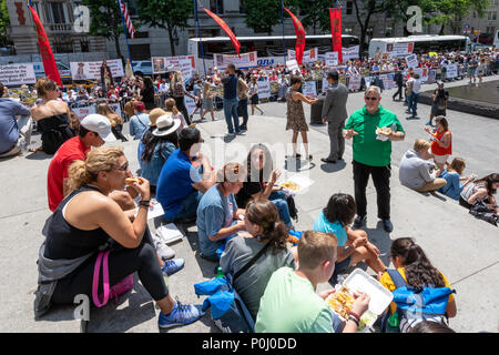 New York, USA. 9th June 2018. Tourist eat in front of New York's Metropolitan Museum of Art while a group of ultra conservative Catholics protest  The Met's 'Heavenly Bodies' Exhibit, which features artifacts donated by the Vatican. The protest was organized by the  American Society for the Defense of Tradition, Family and Property.  Photo by Enrique Shore Credit: Enrique Shore/Alamy Live News Stock Photo