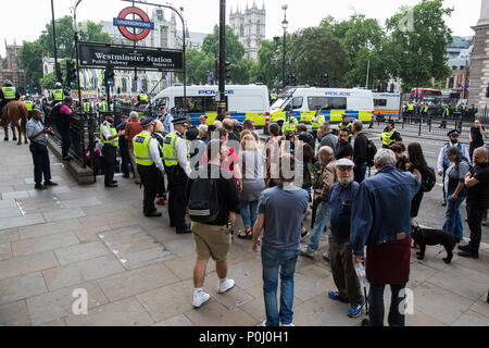 London, UK. 9th June, 2018. Police officers escort anti-fascists protest against the far-right March for Tommy Robinson into Westminster London Underground station in Parliament Street. Tommy Robinson was jailed for contempt of court after using social media to broadcast details of a trial subject to blanket reporting restrictions. Credit: Mark Kerrison/Alamy Live News Stock Photo