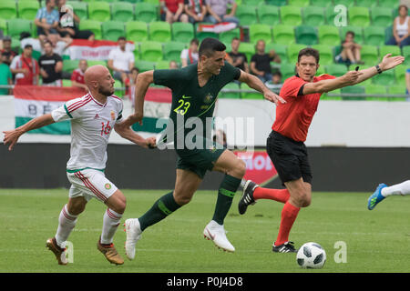 Budapest. 9th June, 2018. Tom Rogic (C) of Australia vies with Jozsef Varga of Hungary during the friendly match at the Groupama Arena in Budapest, Hungary on June 9, 2018. Australia won 2-1. Credit: Attila Volgyi/Xinhua/Alamy Live News Stock Photo