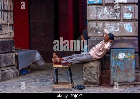 MUMBAI, INDIA - DECEMBER 12, 2014 : A man relaxing at the street of Mumbai Stock Photo