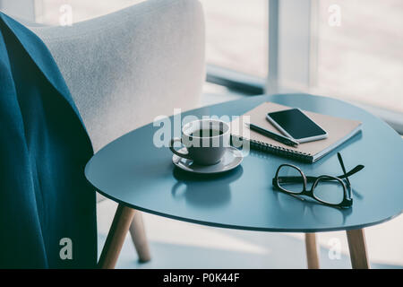still-life with coffee, smartphone, notepad and eyeglasses Stock Photo