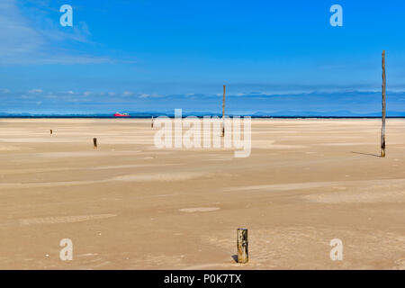 CULBIN BEACH MORAY SCOTLAND MILES OF SANDY BEACH WITH SEA IN THE DISTANCE AND RED SHIP ON HORIZON Stock Photo