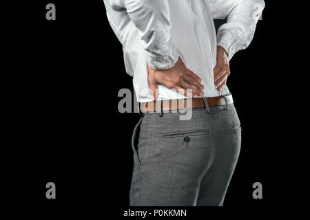 cropped view of businessman having pain in back, isolated on black Stock Photo