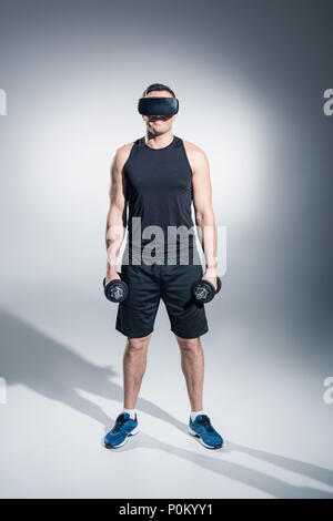 A Man Lifting Dumbbell while Wearing Virtual Goggles · Free Stock