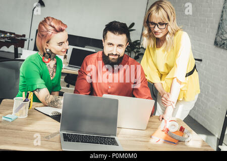 group of young creative workers discussing new project together in office Stock Photo