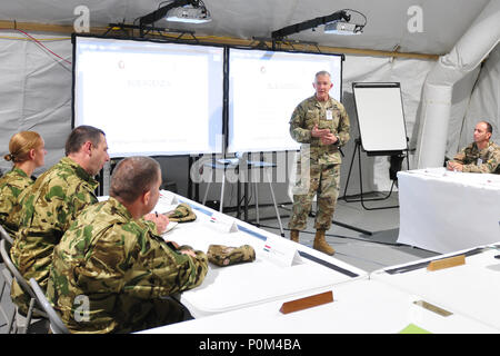 Col. Guy Reedy, chief of staff, 184th Sustainment Command, briefs allied partners on the commands operations during a recent visit to its Tactical Operations Center 4 Jun, Powidz, Poland. 184th SC provides forward mission command overseeing logistics and movements during Saber Strike 18. Host and participating nations benefit from cooperative training opportunities, and we plan to continue these efforts with future Saber Strike exercises. (Mississippi National Guard photo by Staff Sgt. Veronica McNabb, 184th Sustainment Command Public Affairs) Stock Photo