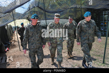 10th Polish Logistics Brigade, FSG commander, Maj. Dominik Trentkiewicz   walks with 184th Sustainment Command, commander, Brig. Gen. Clint E. Walker and Maj. Przemysław Ruman, Deputy Commander during a tour of the Polish compound on 4 Jun, Powidz, Poland. The two sustainment commands will both perform sustainment during Saber Strike 18. We cannot take our relationship with Europe for granted and must maintain the capability to conduct military operations from and with Europe.  (Mississippi National Guard photo by Staff Sgt. Veronica McNabb, 184th Sustainment Command Public Affairs) Stock Photo