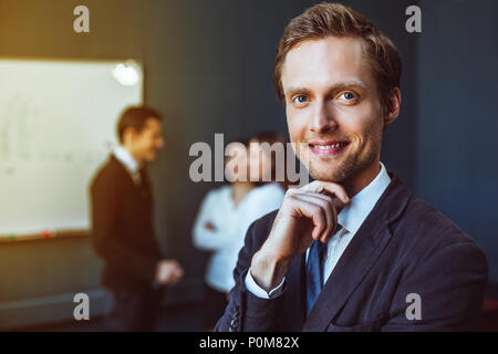 Smartly dressed businessman in office Stock Photo