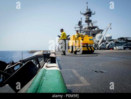 180606-N-AH771-0082  U.S. 5TH FLEET AREA OF OPERATIONS (June 6, 2018) Aviation Boatswain's Mate (Handling) 3rd Class Devin Hubbard, from Bainbridge, Ga., uses a pressure washer to clean the flight deck aboard the Wasp-class amphibious assault ship USS Iwo Jima (LHD 7), June 6, 2018. Iwo Jima, homeported in Mayport, Fla., is on deployment to the U.S. 5th Fleet area of operations in support of maritime security operations to reassure allies and partners, and preserve the freedom of navigation and the free flow of commerce in the region. (U.S. Navy photo by Mass Communication Specialist 3rd Class Stock Photo