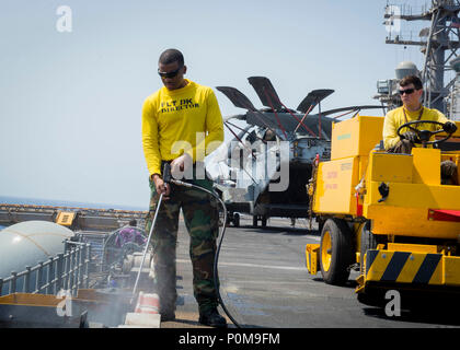 180606-N-AH771-0093  U.S. 5TH FLEET AREA OF OPERATIONS (June 6, 2018) Aviation Boatswain's Mate (Handling) 3rd Class Devin Hubbard, from Bainbridge, Ga., uses a pressure washer to clean the flight deck aboard the Wasp-class amphibious assault ship USS Iwo Jima (LHD 7), June 6, 2018. Iwo Jima, homeported in Mayport, Fla., is on deployment to the U.S. 5th Fleet area of operations in support of maritime security operations to reassure allies and partners, and preserve the freedom of navigation and the free flow of commerce in the region. (U.S. Navy photo by Mass Communication Specialist 3rd Class Stock Photo