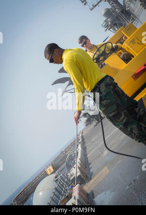 180606-N-AH771-0102  U.S. 5TH FLEET AREA OF OPERATIONS (June 6, 2018) Aviation Boatswain's Mate (Handling) 3rd Class Devin Hubbard, from Bainbridge, Ga., uses a pressure washer to clean the flight deck aboard the Wasp-class amphibious assault ship USS Iwo Jima (LHD 7), June 6, 2018. Iwo Jima, homeported in Mayport, Fla., is on deployment to the U.S. 5th Fleet area of operations in support of maritime security operations to reassure allies and partners, and preserve the freedom of navigation and the free flow of commerce in the region. (U.S. Navy photo by Mass Communication Specialist 3rd Class Stock Photo