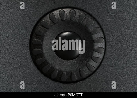 Small black control wheel on black plastic panel. Button with copy space on it Stock Photo