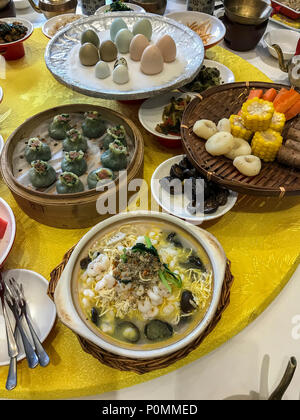 Yangzhou, Jiangsu, China.  Table Setting for Breakfast, Ye Chun Garden Tea House.  Jade Buns (green), shrimp, noodles, mushrooms, crab, assorted boile Stock Photo