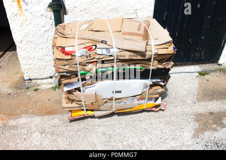 A bale of crushed cardboard ready gfor recycling - John Gollop Stock Photo