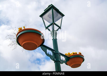 Street light with two vases for flowers agaisnt hazzy sky Stock Photo