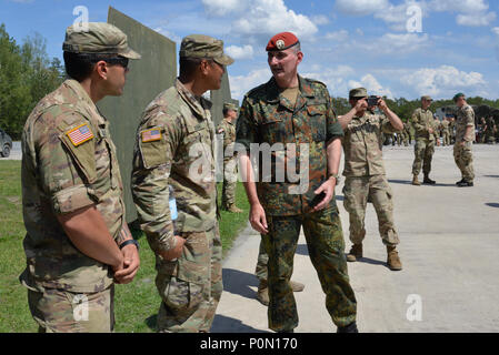 German Brig. Gen. Jörg See, right, Commander of 12th Panzer Brigade, talks with U.S. Soldiers, assigned to the 2nd Battalion, 70th Armored Regiment, 2nd Armored Brigade Combat Team, 1st Infantry Division, during the Strong Europe Tank Challenge (SETC) at 7th Army Training Command's Grafenwoehr Training Area, Germany, June 3, 2018. U.S. Army Europe and the German Army co-host the third Strong Europe Tank Challenge at Grafenwoehr Training Area, June 3 – 8, 2018. The Strong Europe Tank Challenge is an annual training event designed to give participating nations a dynamic, productive and fun envir Stock Photo