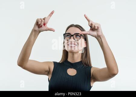 Businesswoman pointing his finger on abstract light background, touching a digital button on a abstract screen, virtual interface, technology. Stock Photo