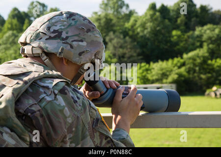 Staff Sgt. James Ahn, an explosive disposal team leader with 49th Ordnance Company from Fort Campbell, Ky., uses a telescope to find improvised explosive devices at the 2018 Ordnance Crucible, Fort A.P. Hill, Va., June 6, 2018. EOD teams are assessed on operations and associated tasks require to provide EOD support to unified land operations to eliminate and/or reduce explosive threats. The Ordnance Crucible is designed to test Soldiers' teamwork and critical thinking sills as they apply technical solutions to real world problems improving readiness of the force.  (U.S. Army photo by Spc. Nath Stock Photo