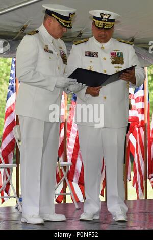 NEW YORK – Rear Adm. Andrew J. Tiongson, commander First Coast Guard District (right), presents a Legion of Merit award to Capt. Michael H. Day, outgoing commander of Coast Guard Sector New York, during a change of command ceremony, June 8, 2018. The change of command is a time-honored ceremony that signifies the absolute transfer of responsibility, authority, and accountability from one person to another. (U.S. Coast Guard photo by Petty Officer 3rd Class Hunter Medley) Stock Photo