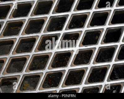 Closeup of a sewer grate with a diamond pattern in St Paul de Vence, France Stock Photo