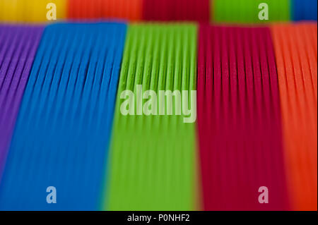 Close-up of multicolored foam craft sticks creating abstract background patterns. Stock Photo