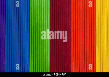 Close-up of multicolored foam craft sticks creating abstract background patterns. Stock Photo