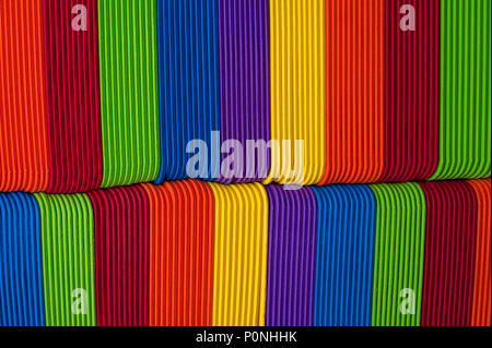 Close-up of multicolored foam craft sticks creating abstract background patterns. Stock Photo