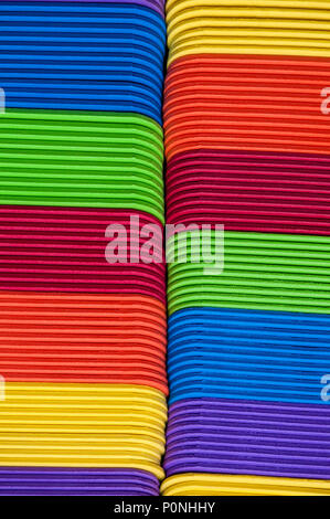 Close-up of multicolored foam craft sticks creating abstract background patterns. Stock Photo